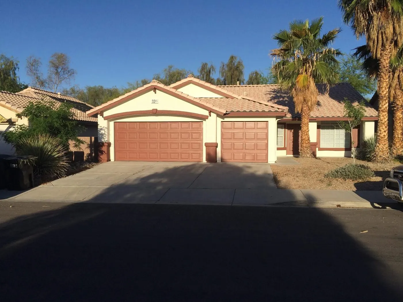 After: full exterior repaint with fresh stucco color and terracotta garage doors by MK Painting Las Vegas
