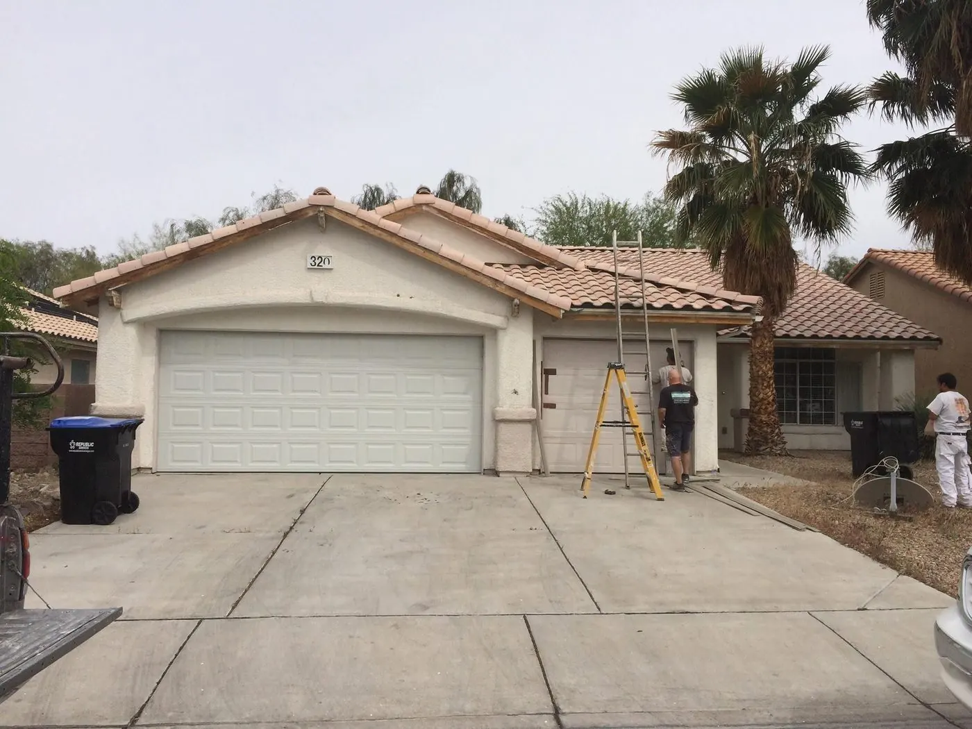 Before: faded exterior stucco and garage doors on a Las Vegas home, prepped for repaint by MK Painting